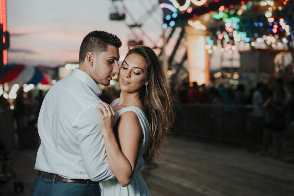 Seaside Heights Boardwalk Summer Ocean County Beach Engagement Session July Love Save the Dates Carnival Games Rides Pink Sky Sunset