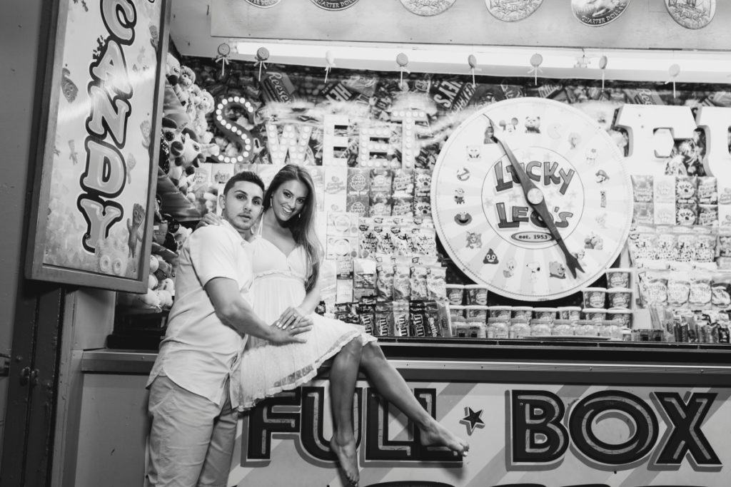 Seaside Heights Boardwalk Summer Ocean County Beach Engagement Session July Love Save the Dates Carnival Games Spin the Wheel Candy Lucky Leo's Black and White