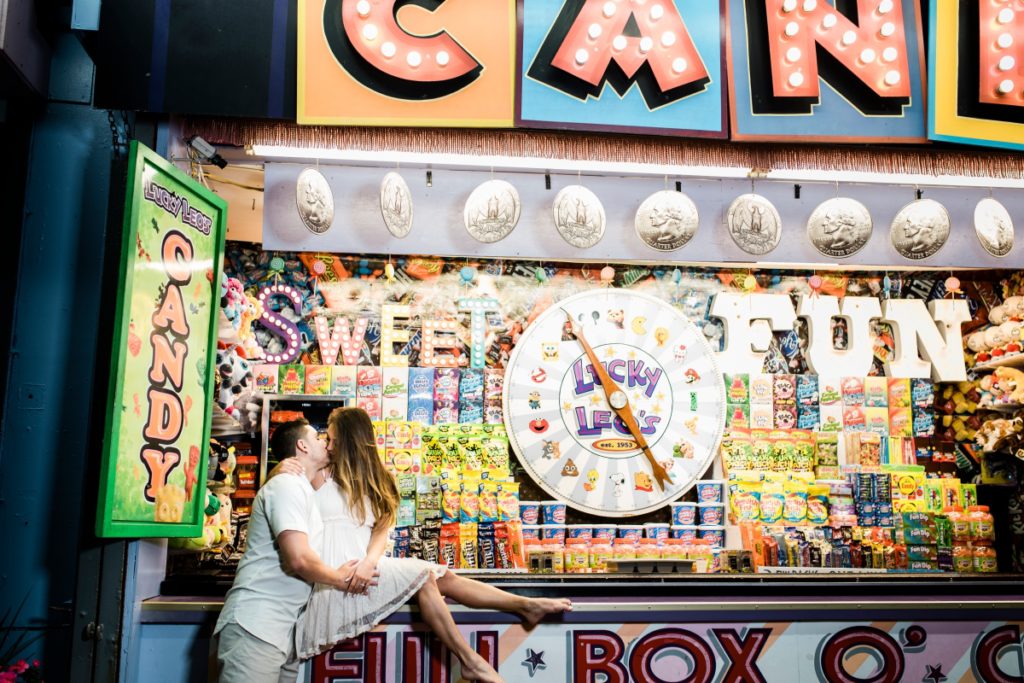 Seaside Heights Boardwalk Summer Ocean County Beach Engagement Session July Love Save the Dates Carnival Games Spin the Wheel Candy Lucky Leo's Casino Pier Amusement Park