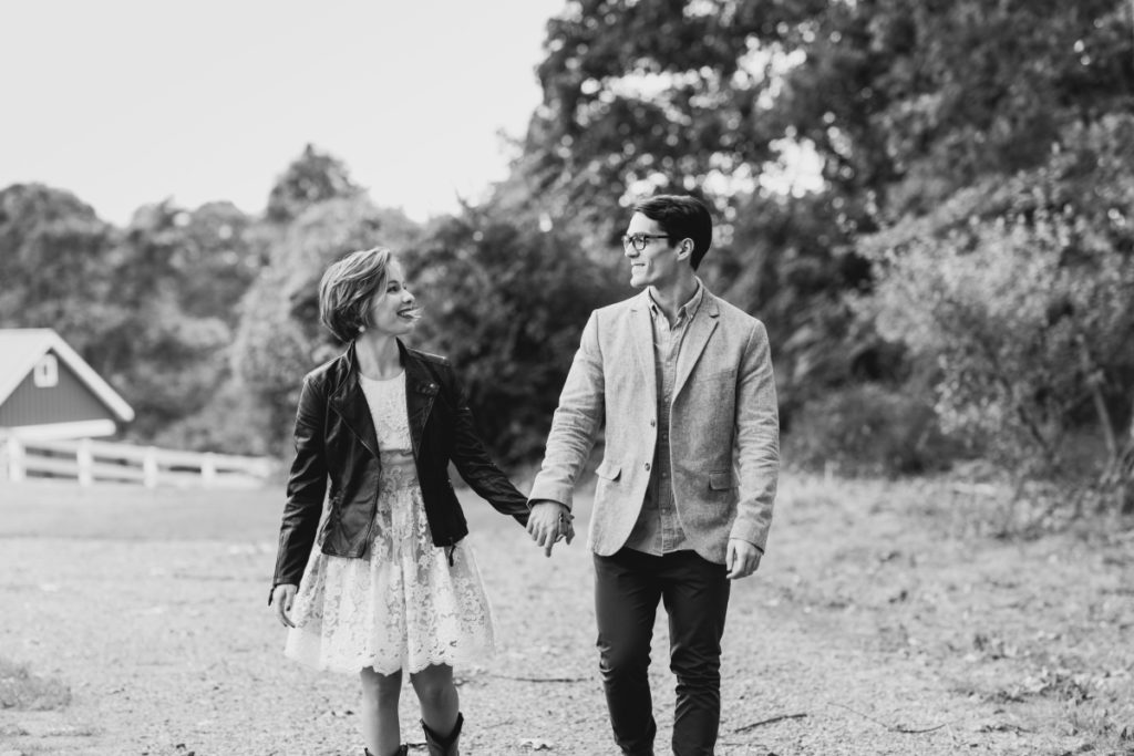 black and white couple happy leather jacket lace dress boots Bluebird Farm Alpacas Engagement fall autumn smiling happy candid cowboy boots