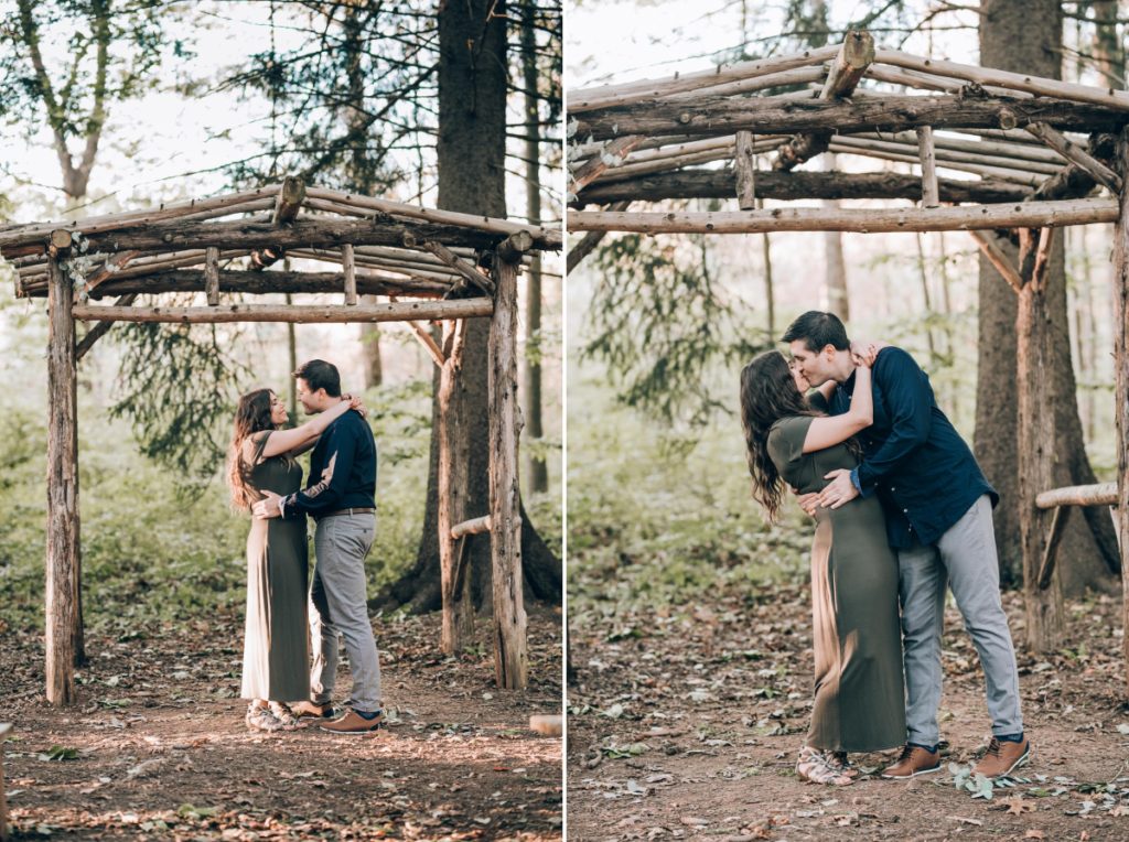 kissing wooden pergola trees forest deserted village of feltville watchung reservation mountainsidenj newprovidencenj autumn fall​engagement session rustic​ ​wedding​ ​ ​​