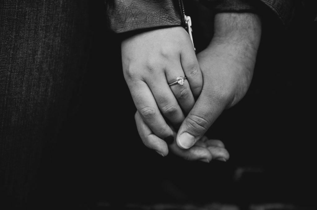 black and white engagement ring holding hands champagne alleyway exposed brick fall autumn september engagement session Hoboken Lackawanna Train Station  NY new york new york wedding east coast photographers love story new jersey