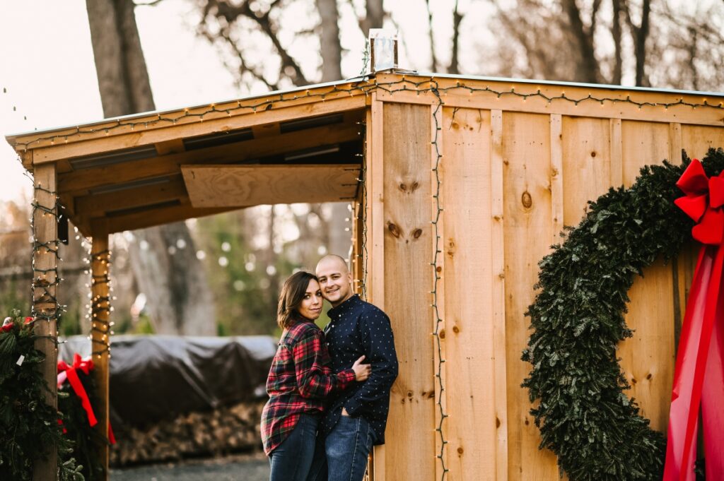 Hidden Pond Tree Farm Mendham NJ Sunset Engagement Session Christmas Tree Farm Holiday Season Love Engaged wreathe