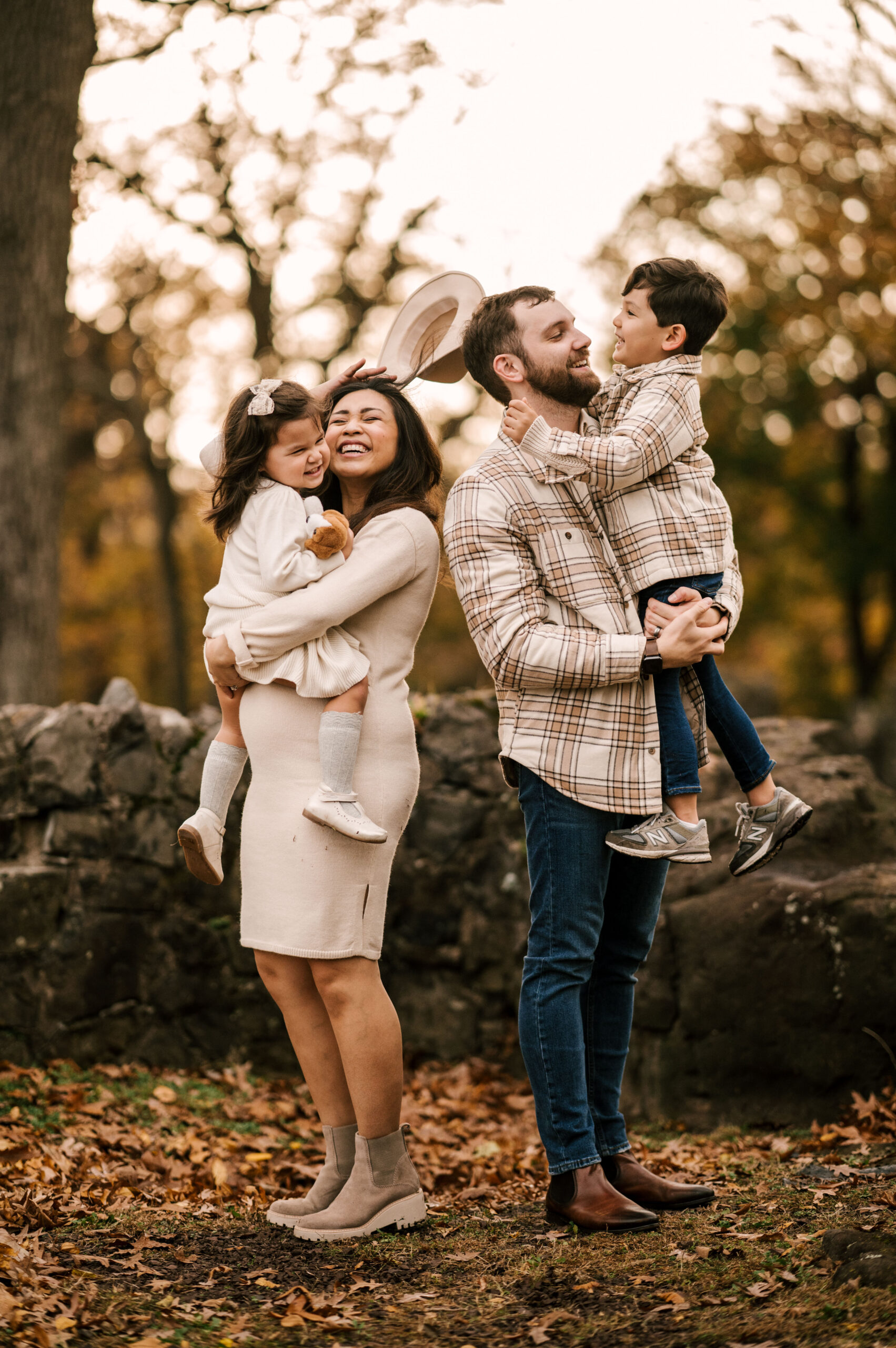 family laughing and having fun at kip's castle park family photo shoot in the November Fall season