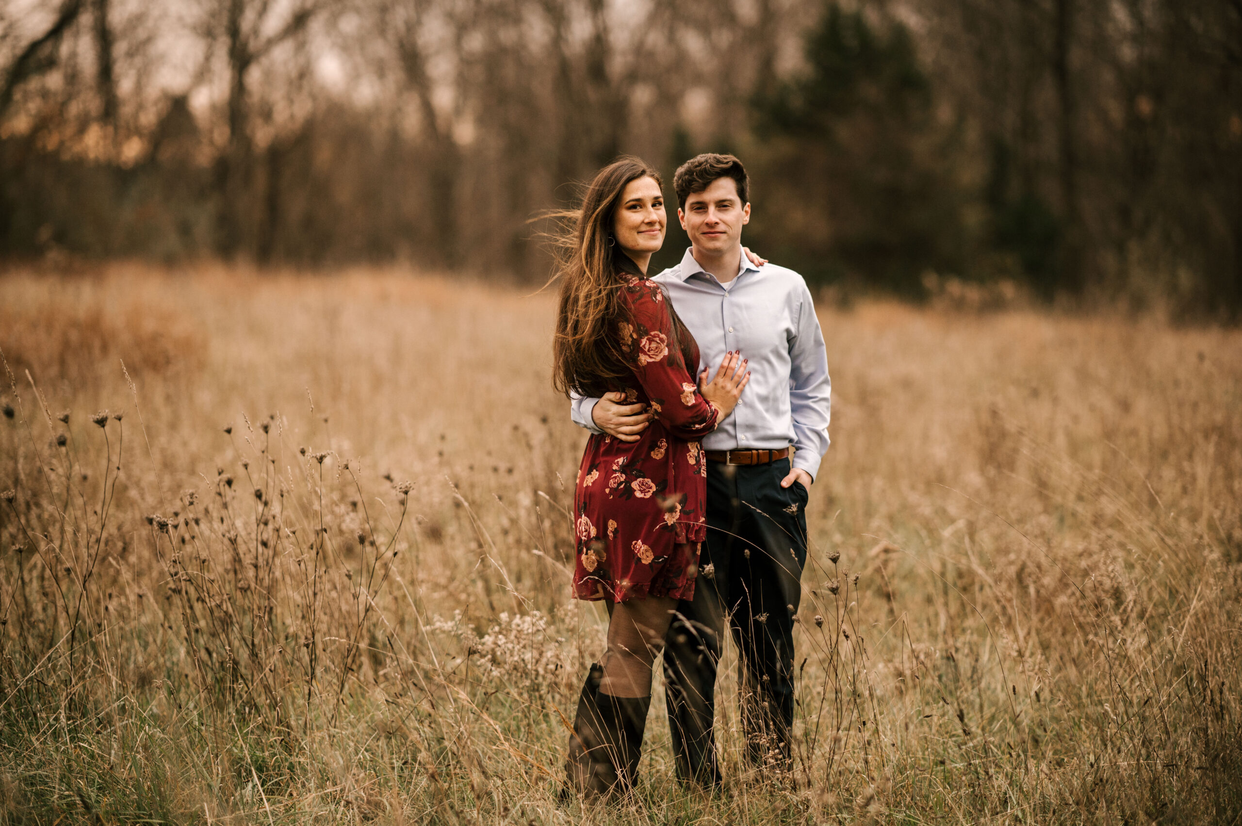 Couple lovingly holding each other at their engagement session in the NJ Botanical Gardens at Ringwood State Park. Castle at Skylands Manor