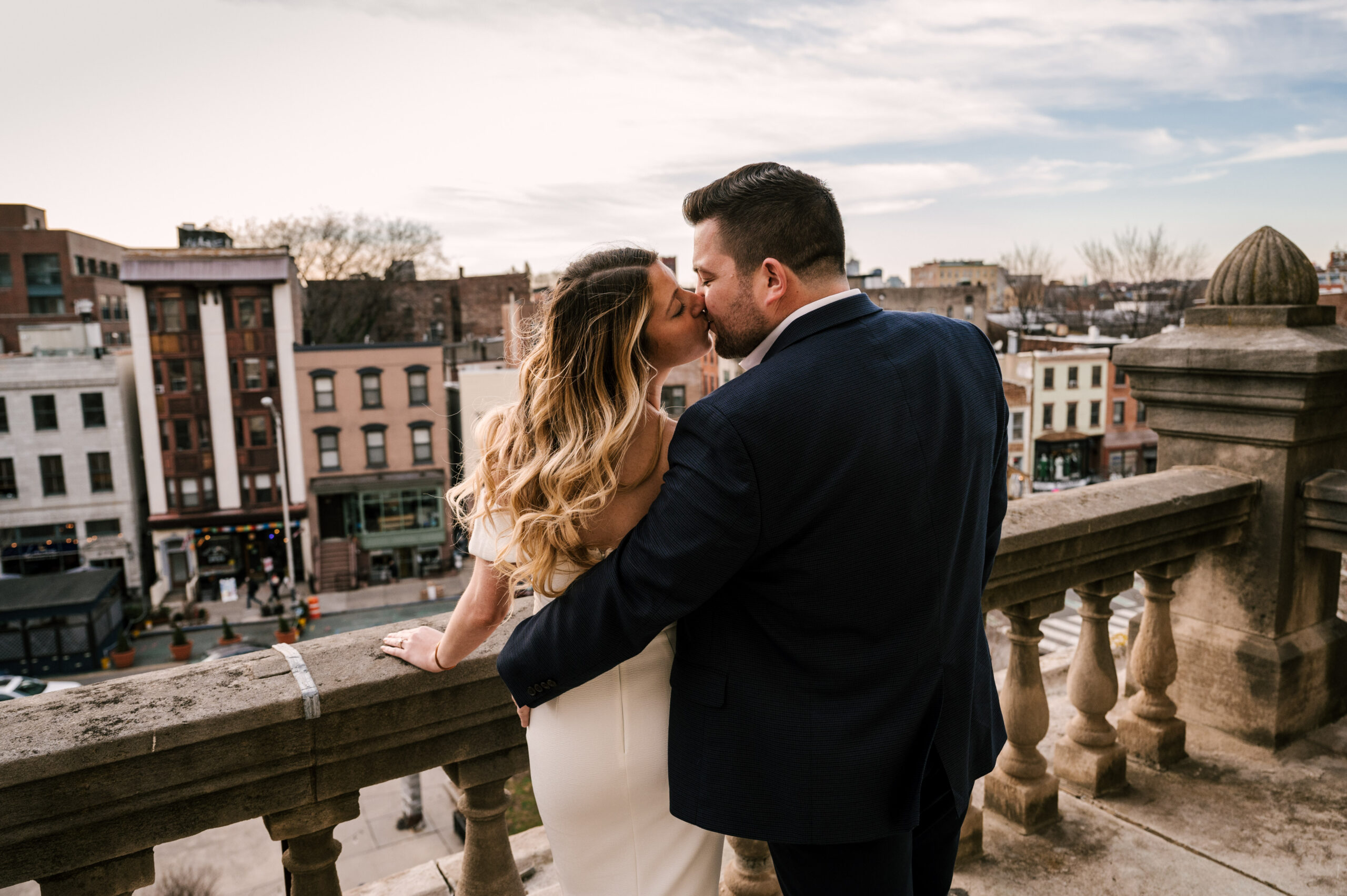 ouple kissing on the balcony overlooking Spring Hudson County Courthouse Ceremony in Jersey City