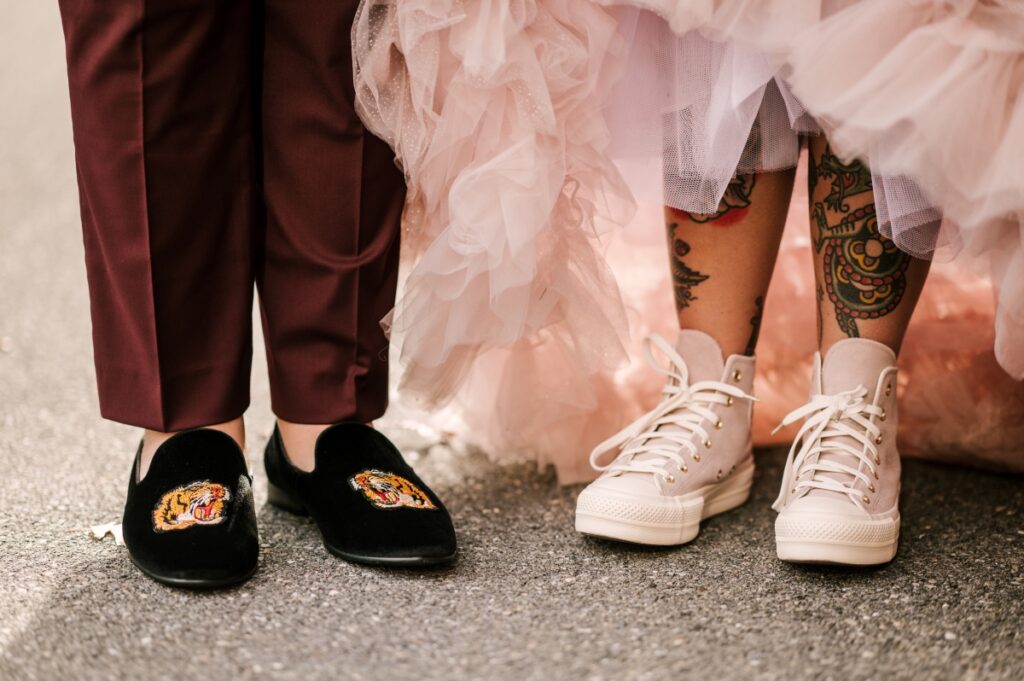 Pink converse and custom loafers with tiger patch. Bride with tattoos. bride and groom details