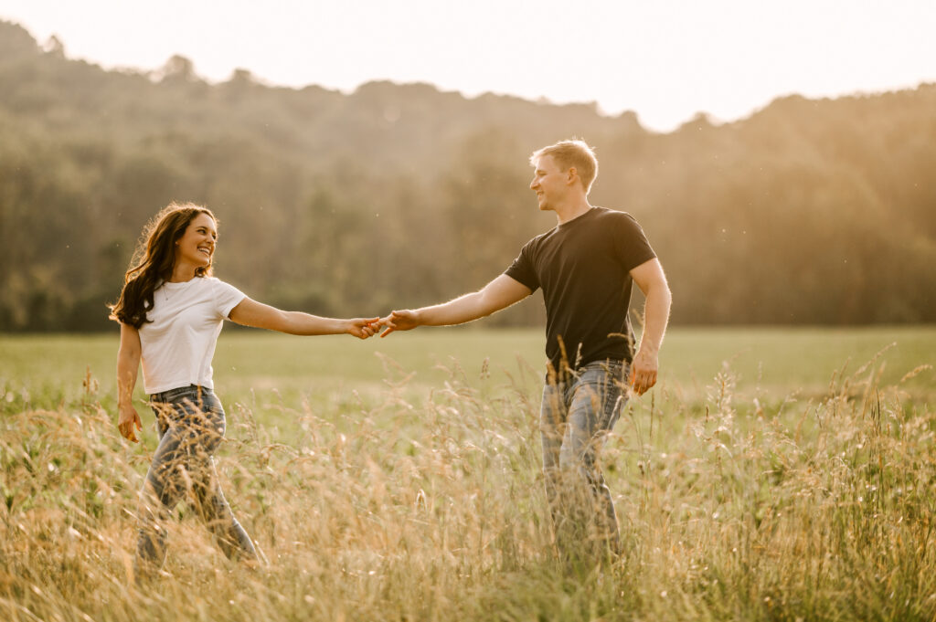 Young couple summer engagement session in June. Private family farm in Asbury, New Jersey. Fun carefree and candid photography. New Jersey Photographer