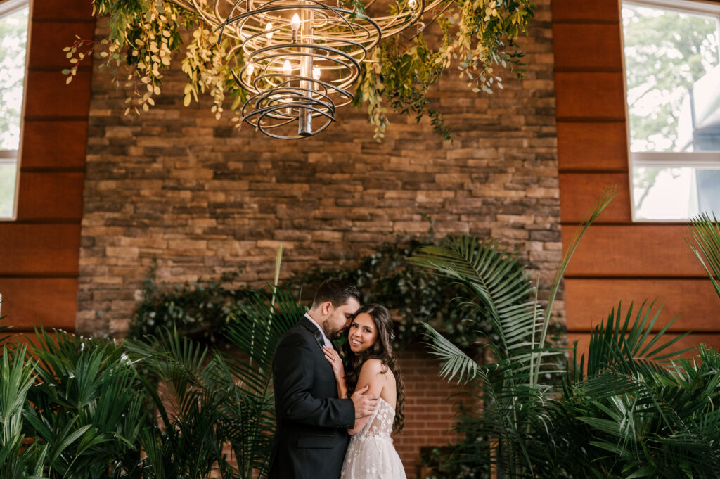 bride and groom surrounded by botanical plants at stone house at stirling ridge in warren new jersey
