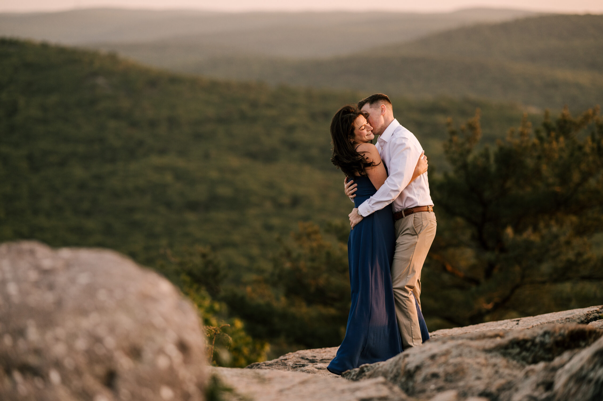 couple embracing at the top of Pekins Memorial Tower in Stony Point New York during a May sunset