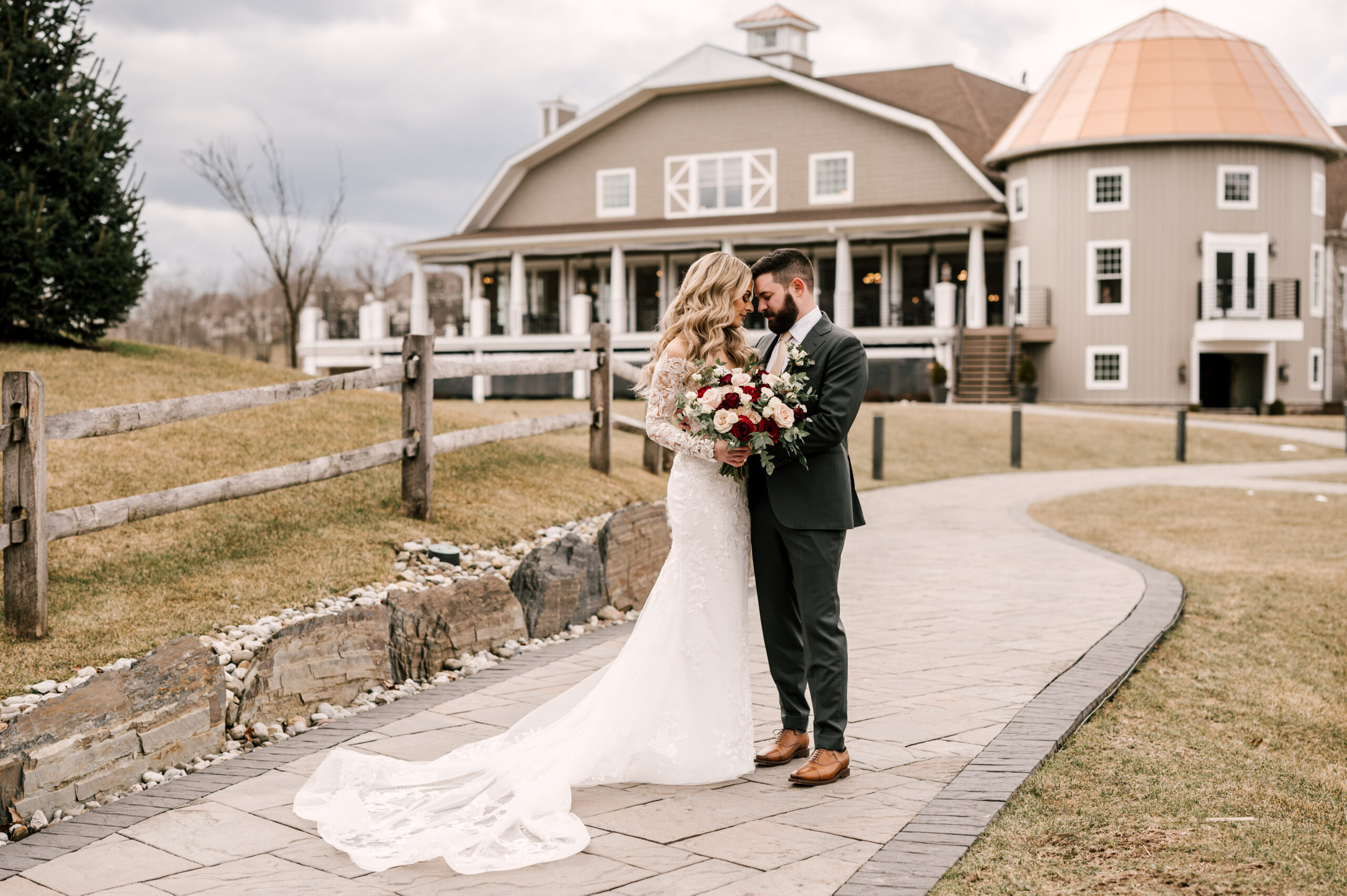 Bride and groom in front of wedding venue Bear Brook Valley in Fredon Township New Jersey in March