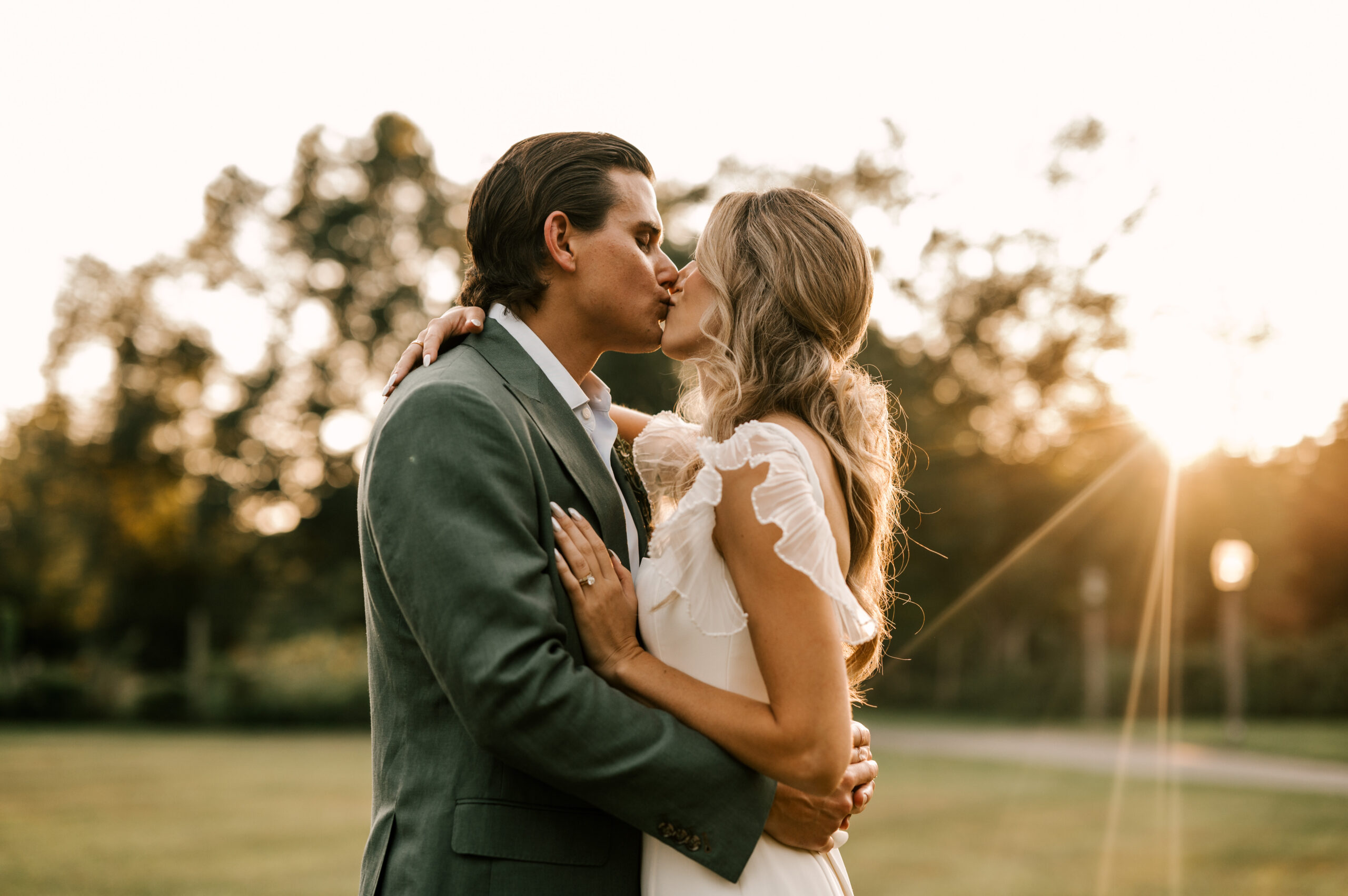 bride and groom kiss in the sunset golden hour light at waterloo village in stanhope new jersey