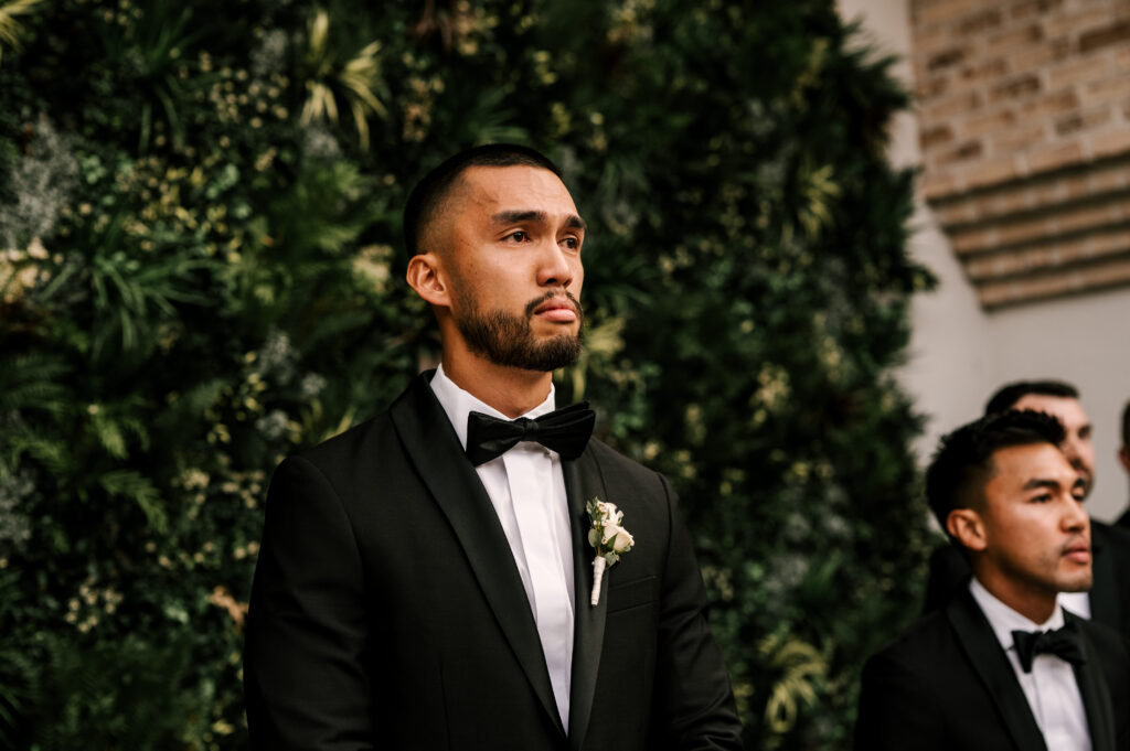 The groom getting emotional as he sees his bride walk down the aisle during the ceremony at the Refinery at Perona Farms.