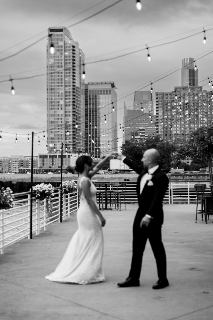 The groom twirling his bride outside at Battello in Jersey City.