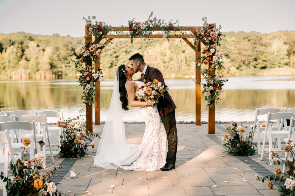 bride and groom dip kiss after ceremony at Rock Island Lake Club