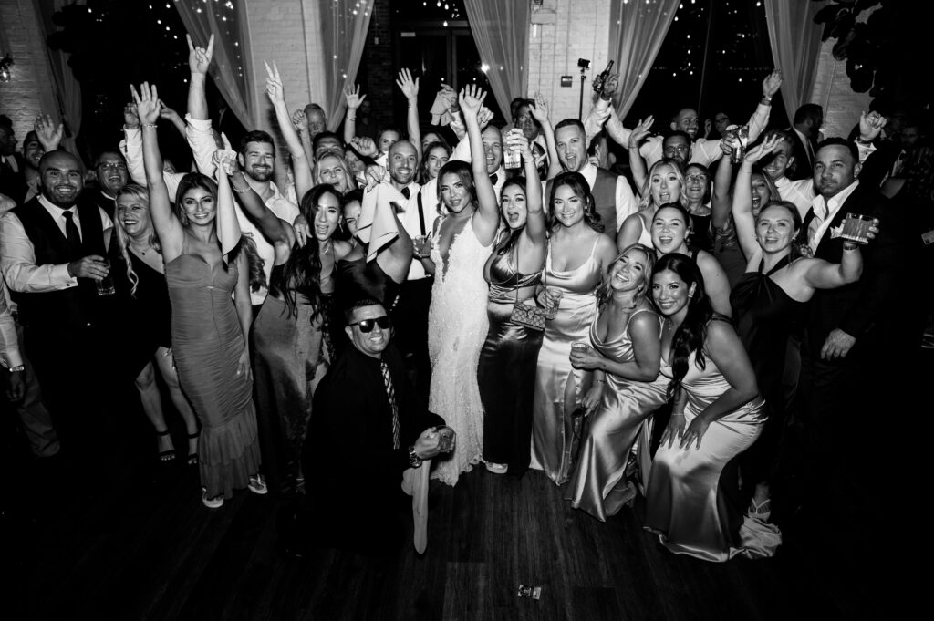 Wedding guests happily cheering on the newlyweds at the reception at Battello.