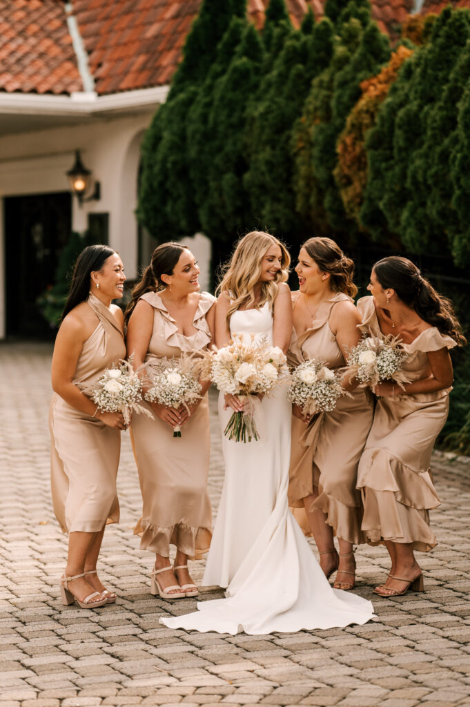 The bridesmaids smiling and giggling together before the ceremony at Perona Farms.