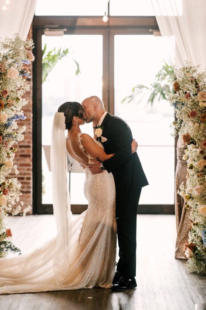 The newlyweds sharing their first kiss and husband and wife at Battello in Jersey City.