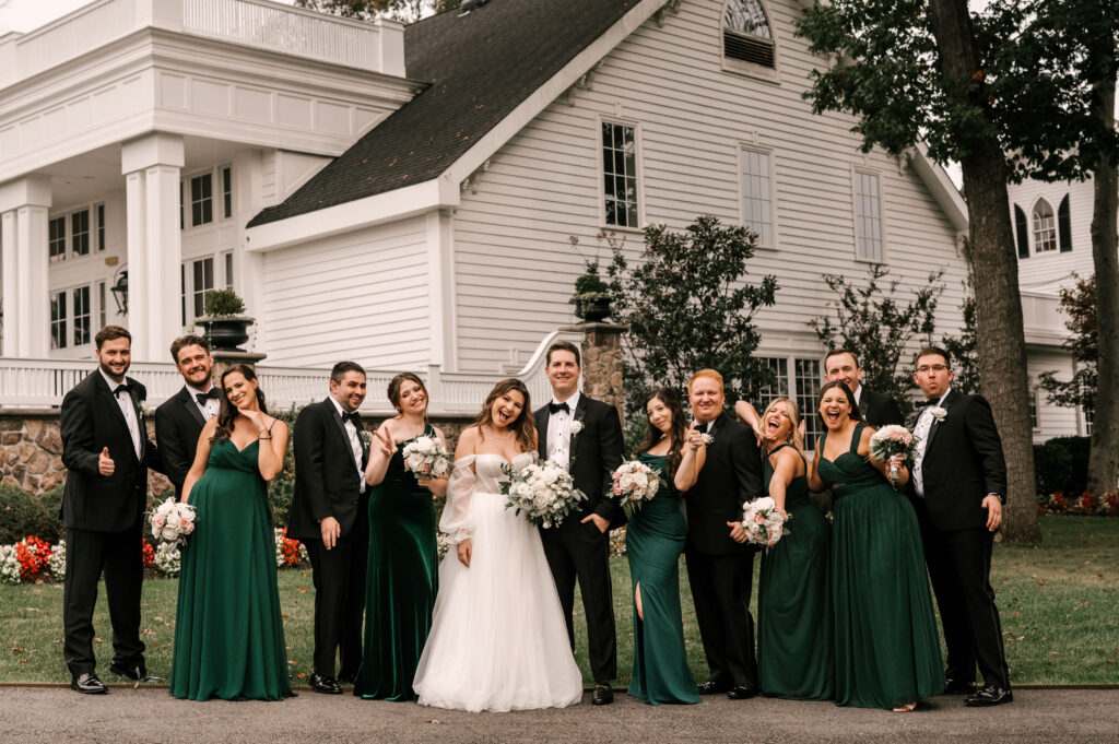 The bridesmaids and groomsmen smiling and supporting the couple.