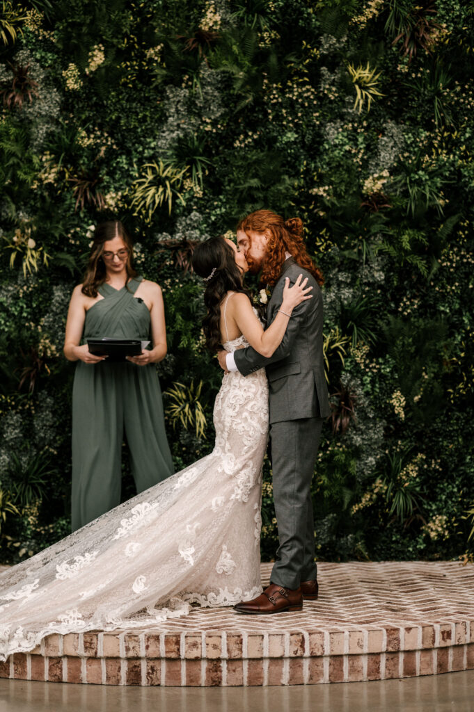 The couple embraces as they share their first kiss as husband and wife.