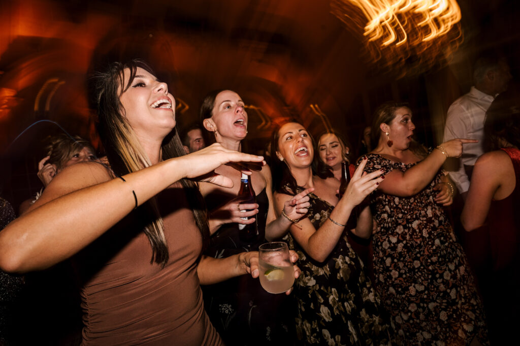 Guests on the dance floor smiling and dancing at the reception at Ashford Estate.