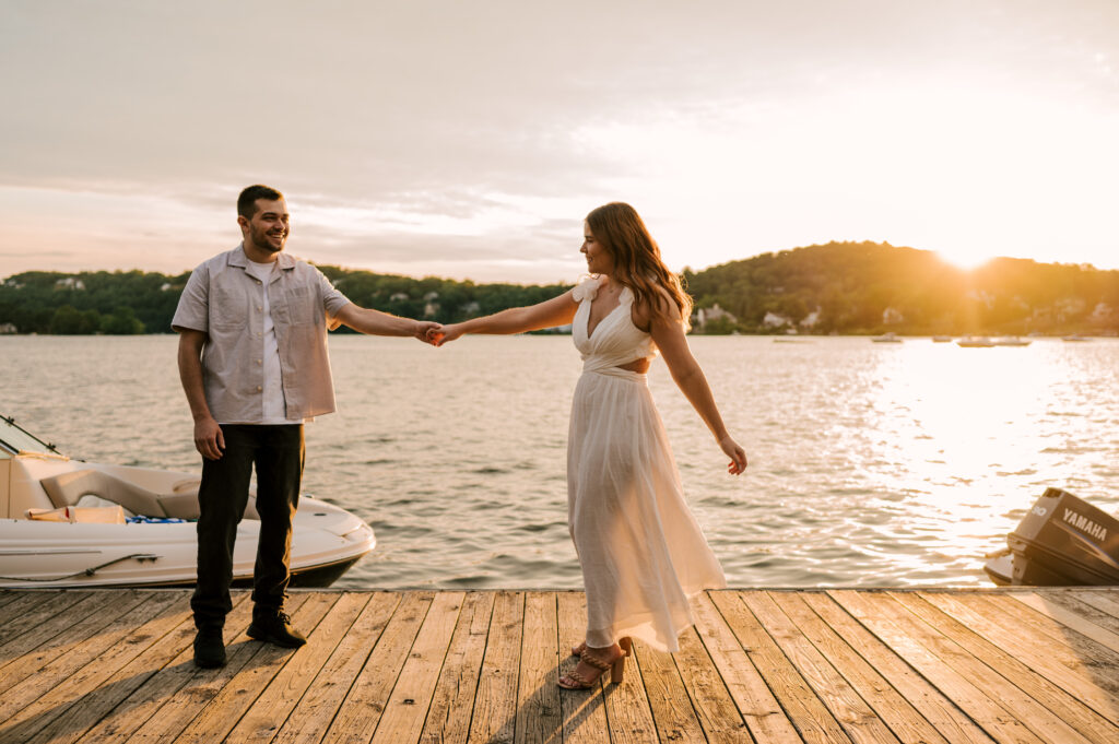 The couple dancing on the doc during sunset on the dock at Lake Mohawk.