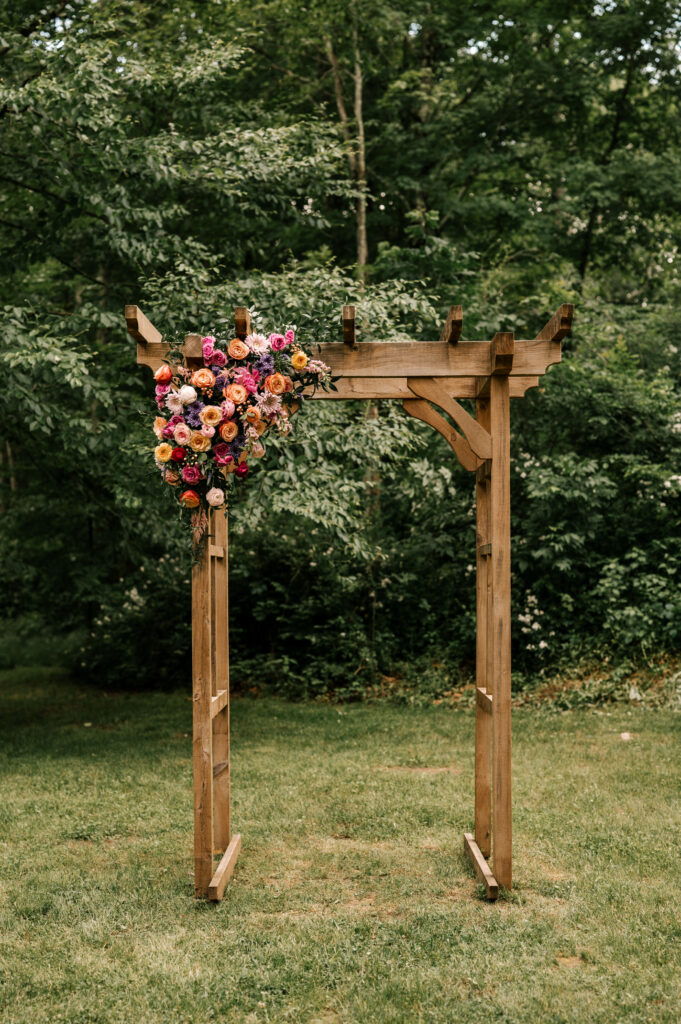 The arch for the wedding decorated with flowers at at Wallenpaupack Creek Farm.