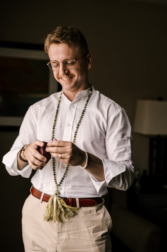 The groom putting on his cologne before the ceremony at Waterloo Village.