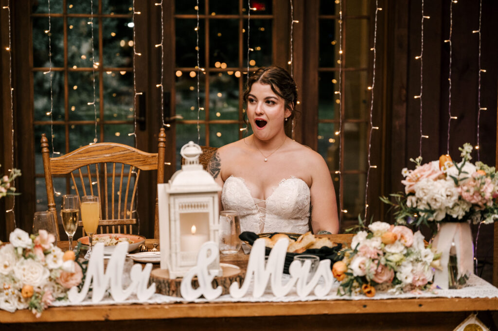 The bride's reaction to her husband singing a song for her at the reception at Waterloo Village.
