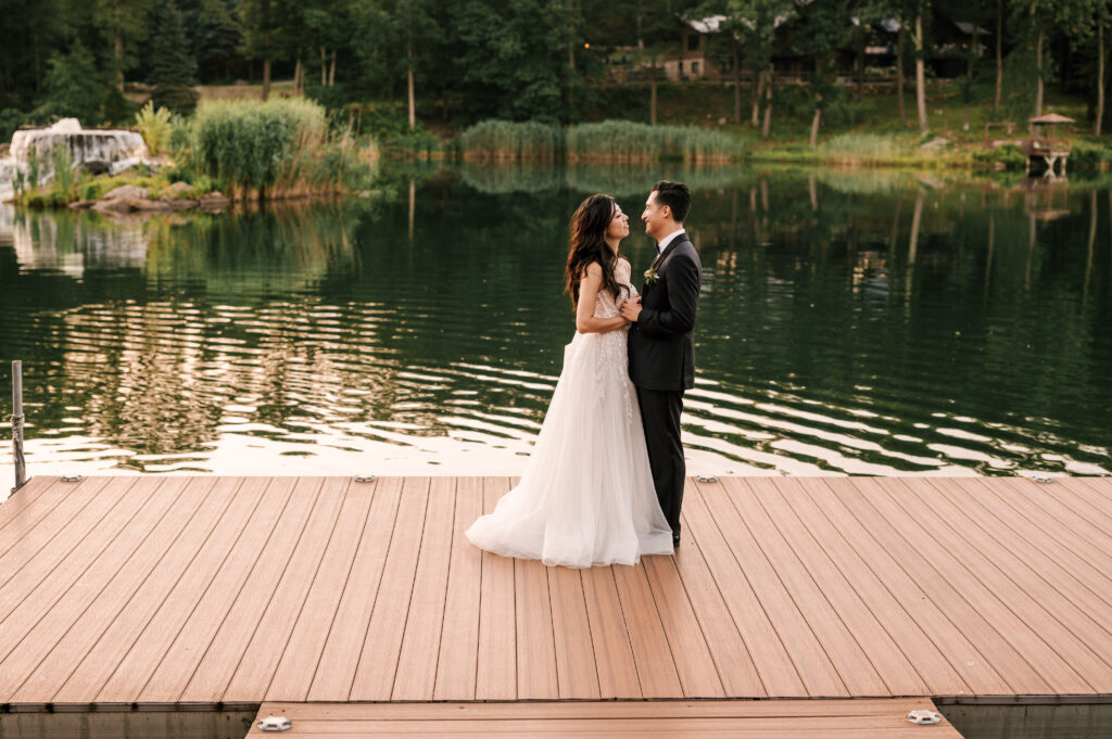 The newlyweds dancing on the dock by the lake at Rock Island Lake Club.