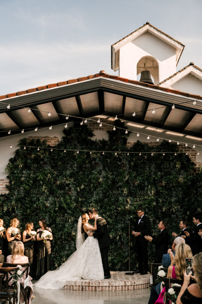 The couple's first kiss as husband and wife at Perona Farms Refinery.