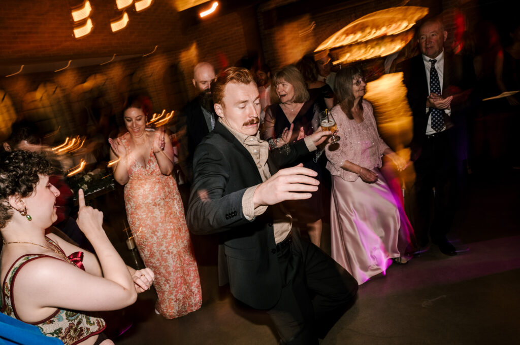Guests dancing during the reception at Perona Farms Refinery.