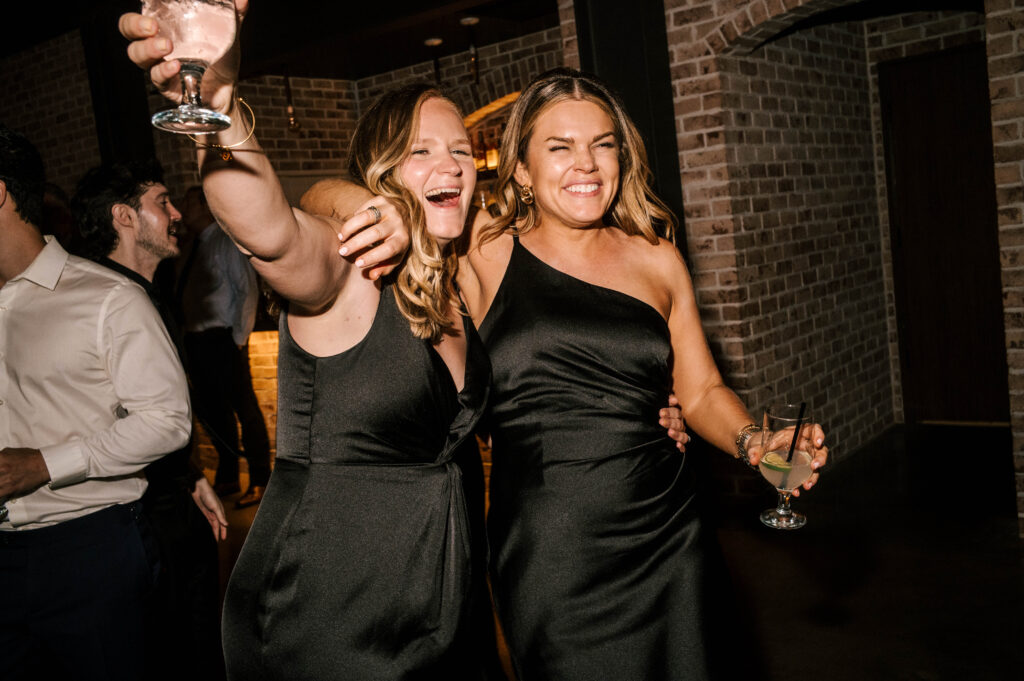 Bridesmaids dancing and enjoying their time at the reception at Perona Farms Refinery.