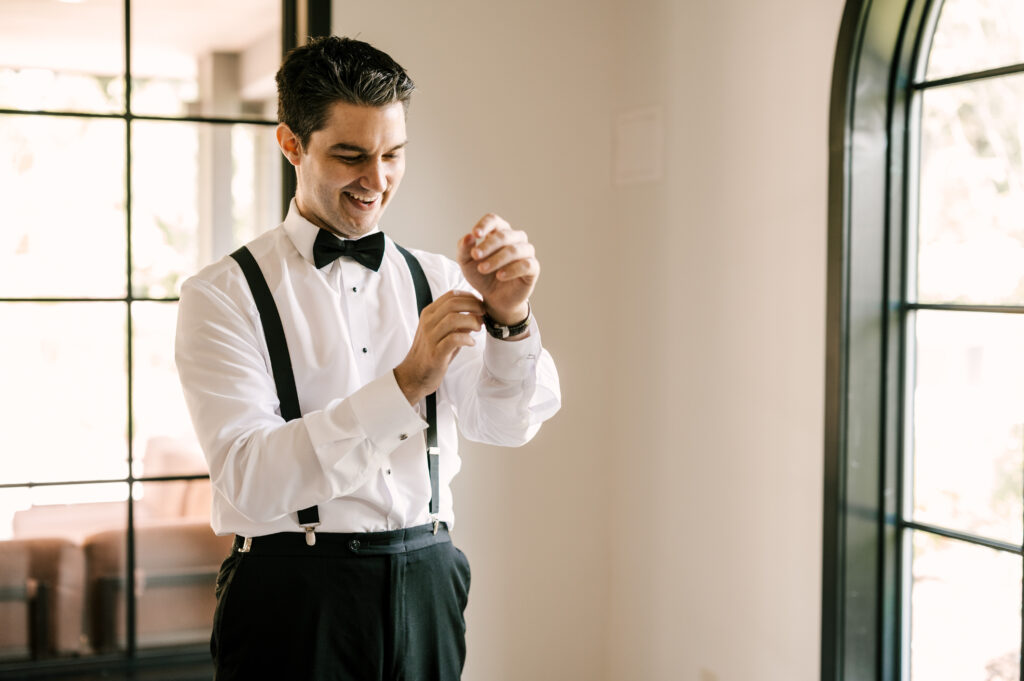 The groom putting on his watch before the ceremony at Perona Farms Refinery.