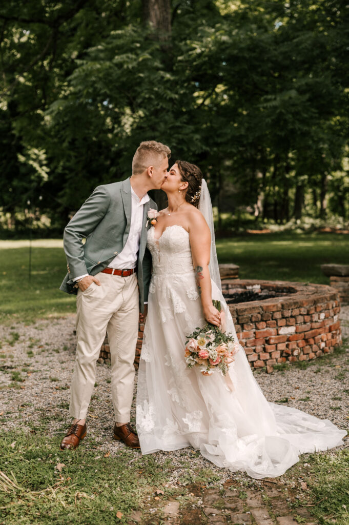 The bride and groom sharing a kiss before the ceremony at Waterloo Village.