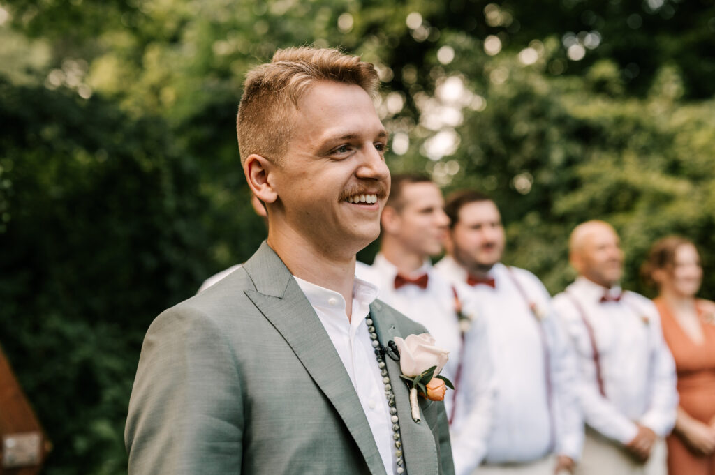 The groom happily waiting for his bride to walk down the aisle during the ceremony at Waterloo Village.