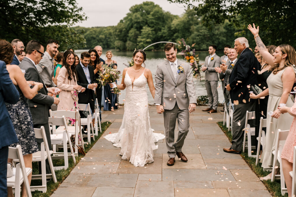 bride and groom walking back up the aisle at their ceremony for indian trail club wedding in Franklin Lakes NJ