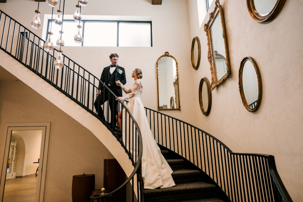 bride and groom ascending stairs at perona farms reserve