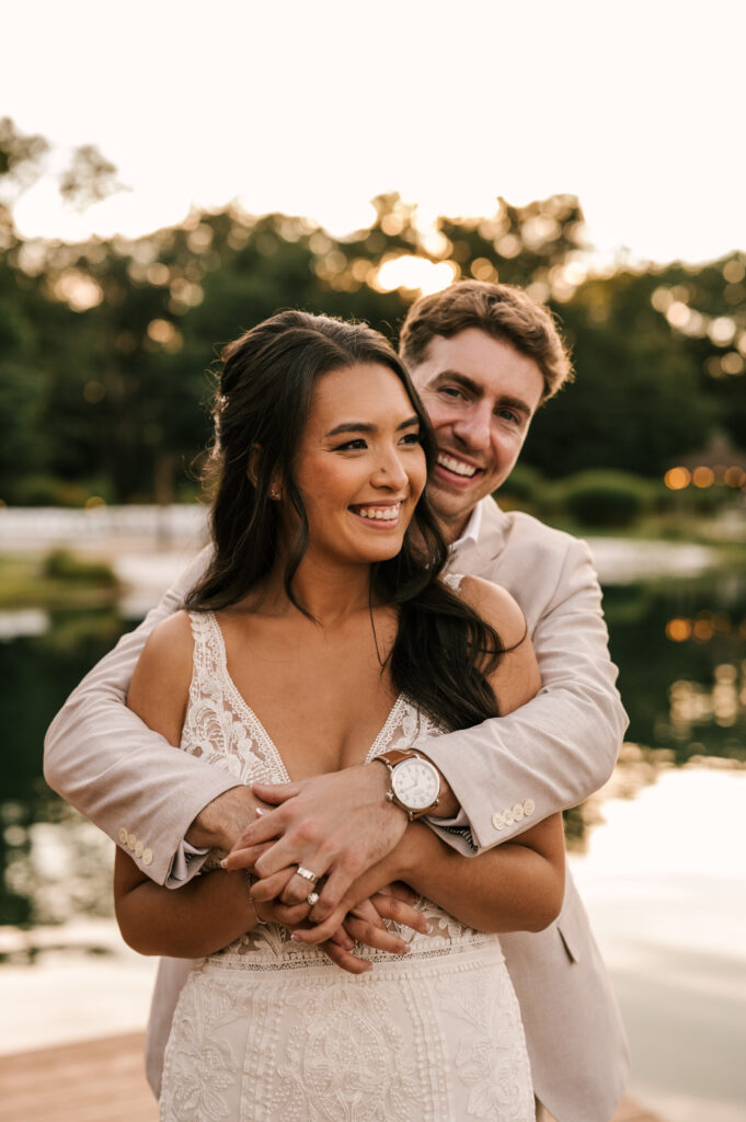 bride and groom embracing on dock at sunset at Rock Island Lake Club