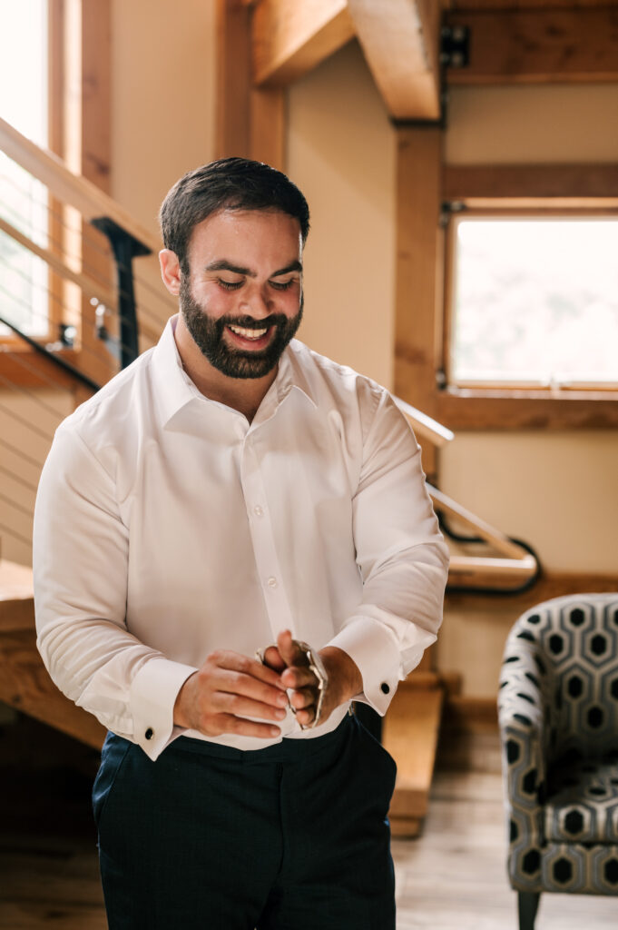 The groom putting on his watch while getting ready for the ceremony at Rock Island Lake Club.