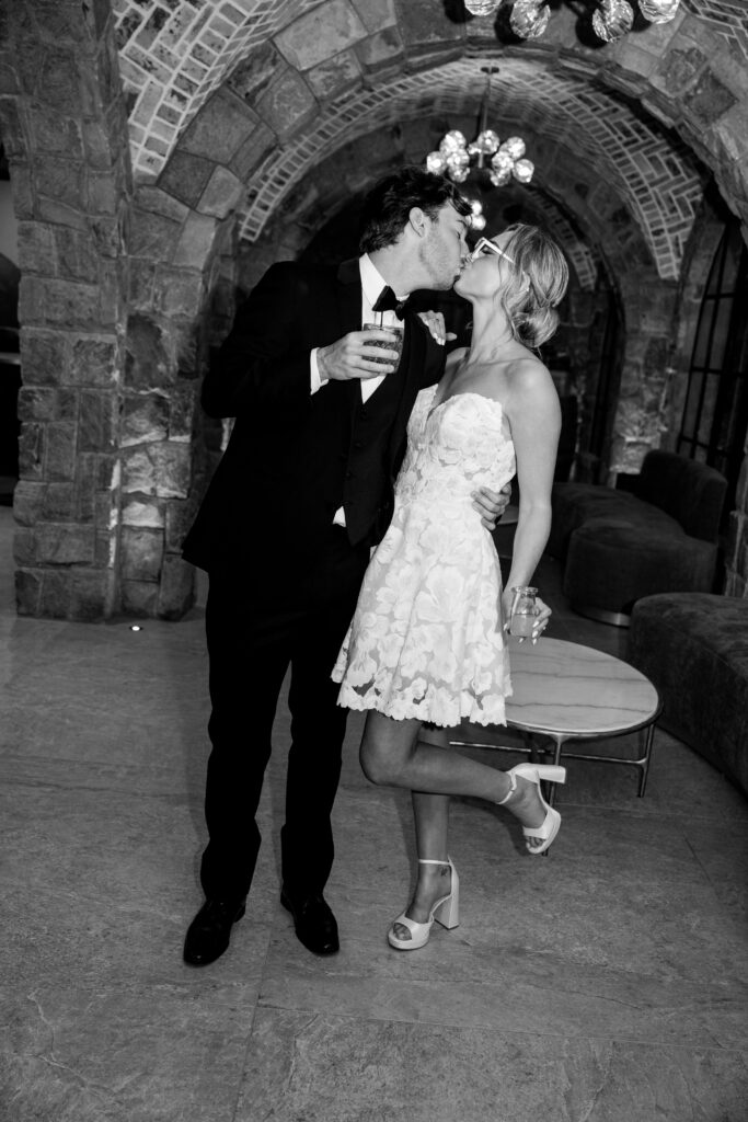 black and white vintage nostalgia bride and groom kiss at Perona Farms Refinery