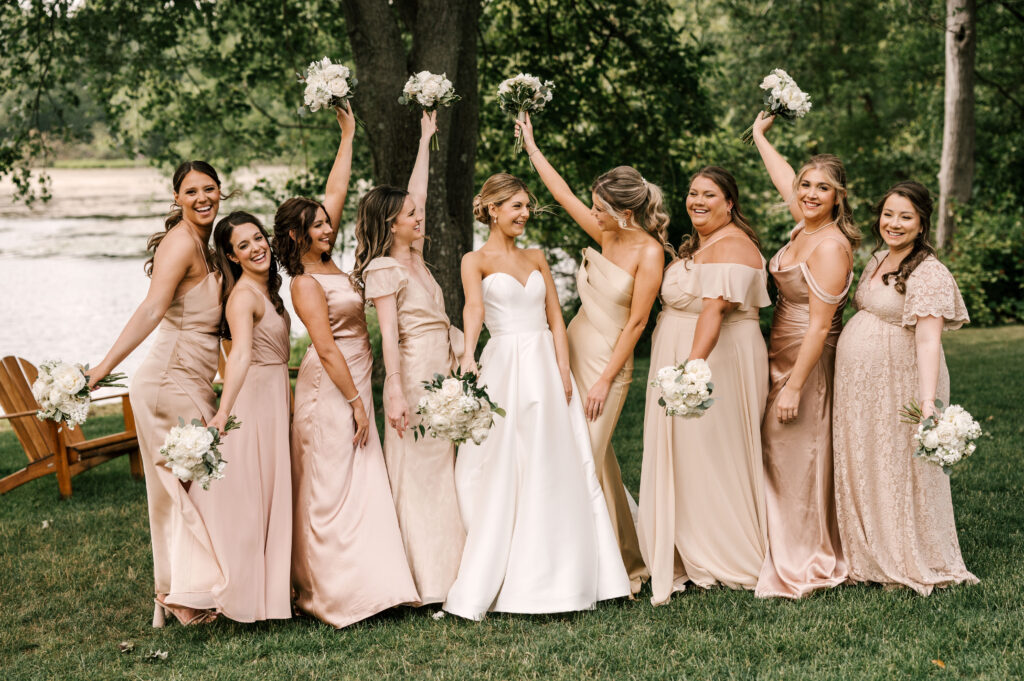 bridesmaids cheer by the lake at Indian trail club, new jersey wedding venue