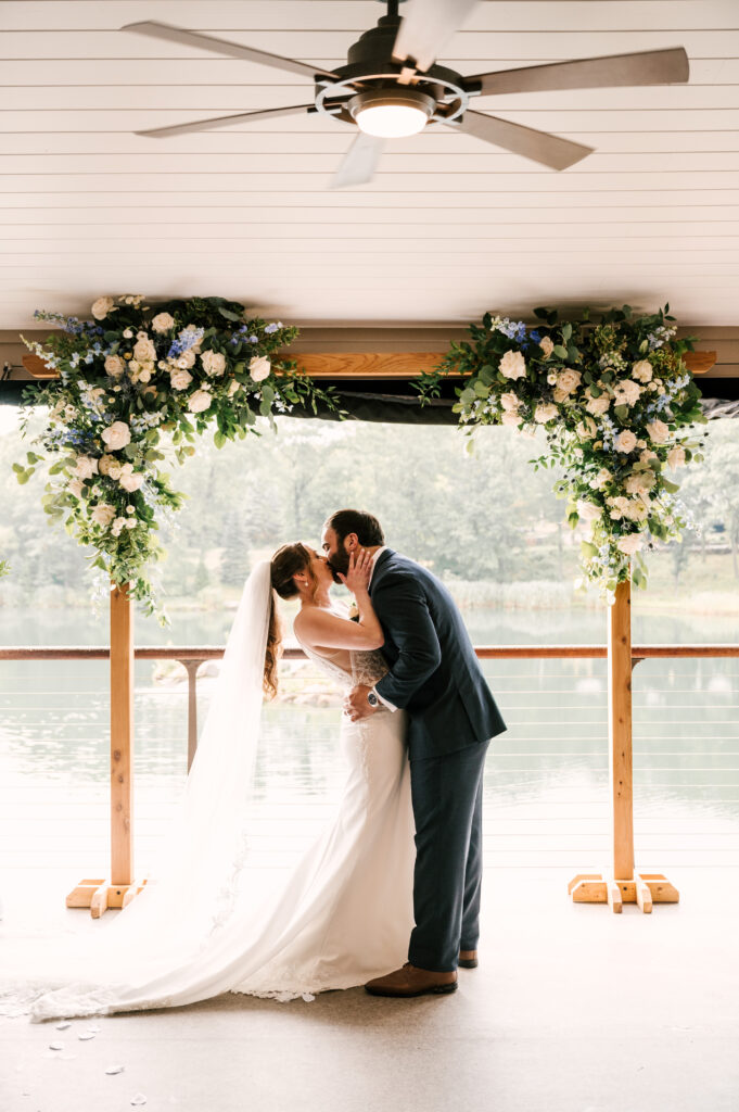 The couple's first kiss as husband and wife during the ceremony at Rock Island Lake Club.
