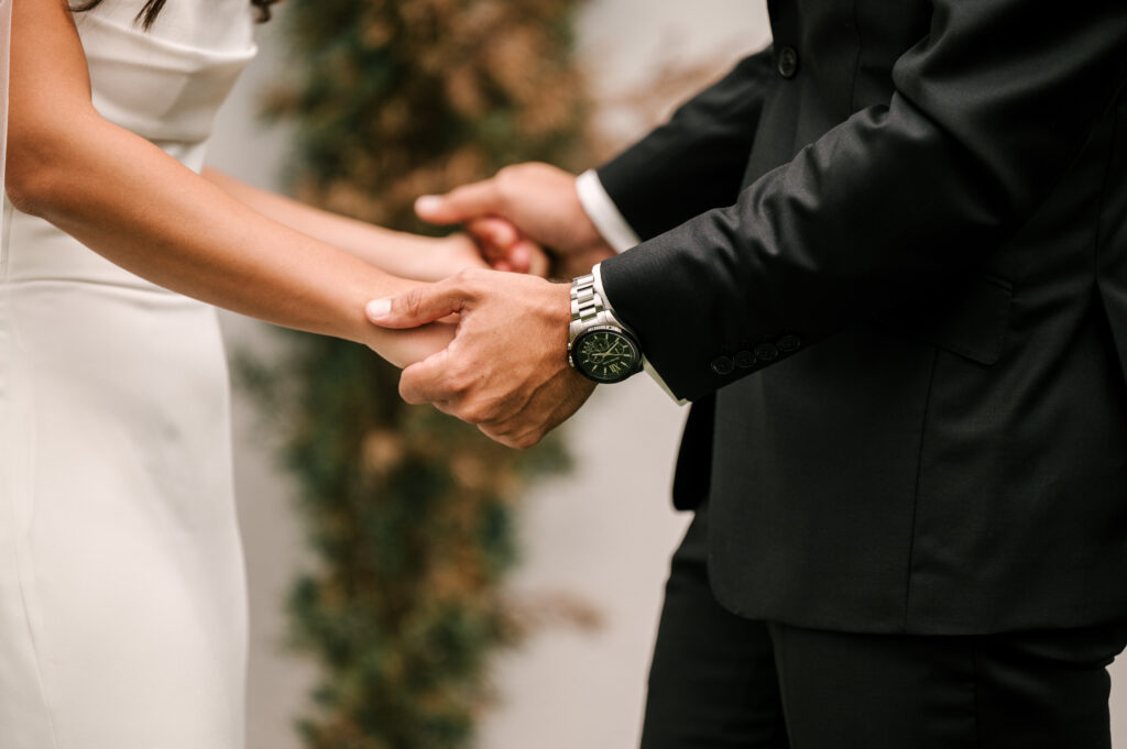 The couple holding each other's hands at Perona Farms Reserve.