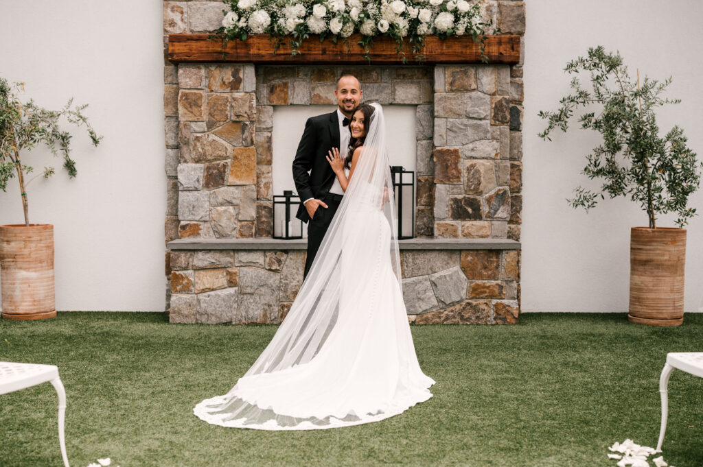 The bride and groom, smiling while in an embrace before the ceremony at Perona Farms Reserve.