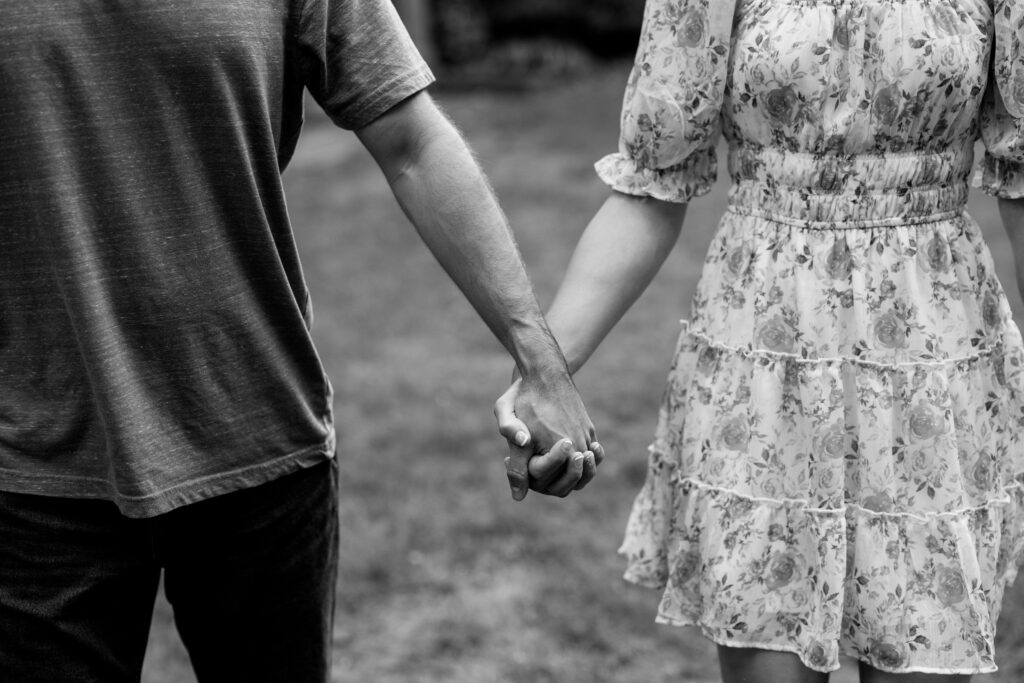 couple holding hands during july engagement photoshoot