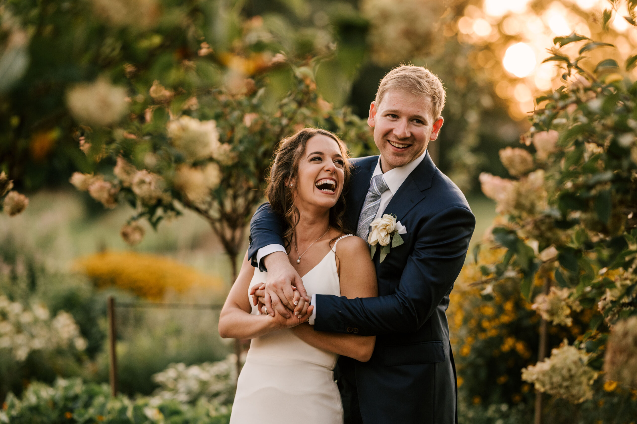 Bride and groom kiss in the golden sunset light at the Farm Bakery and Events in PA. Summer wedding in August