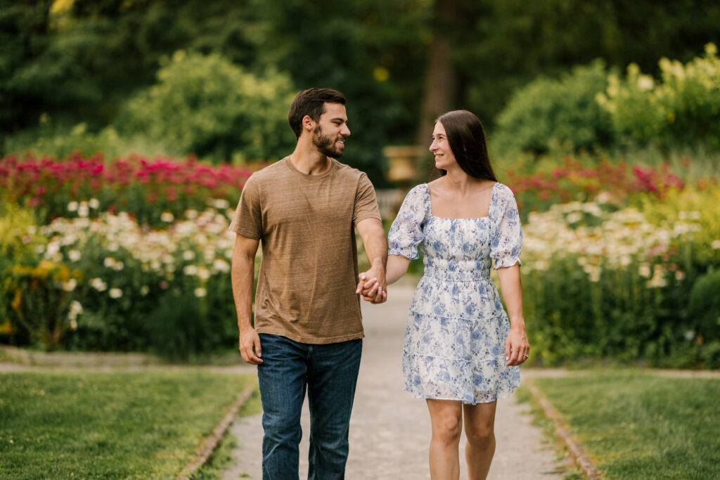 couple walking in floral field at van vleck house and gardens in montclair nj 
