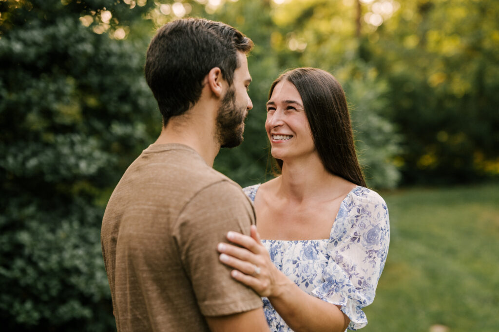 Bride to be smiling at future husband during engagement shoot at van vleck house and gardens