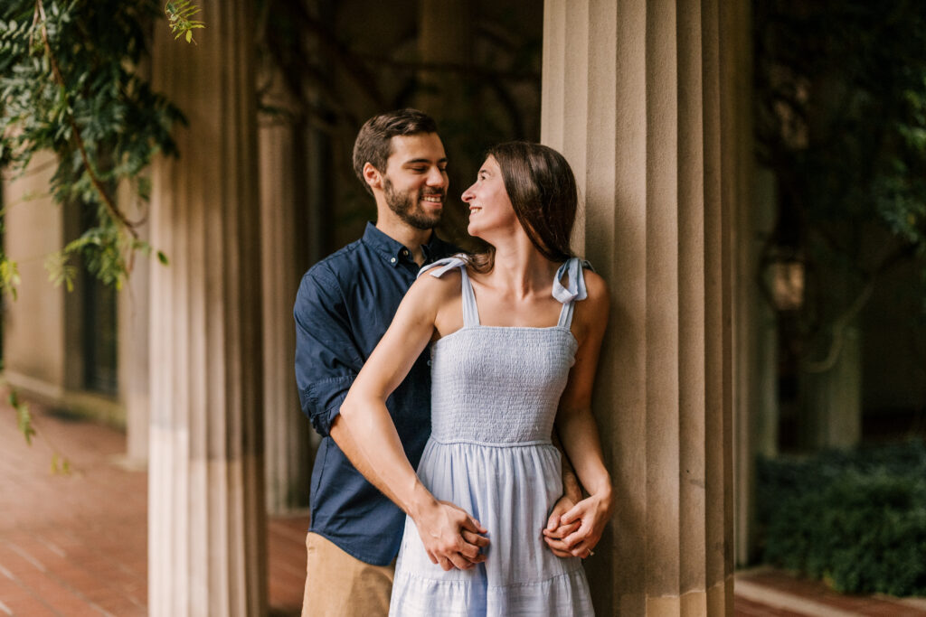 couple standing by columns during engagement shoot at Van Vleck House and Gardens in Montclair NJ
